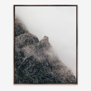 Abstract vertical fine art photograph of rocky mountain face in the Austrian alps in Vorarlberg with fog.