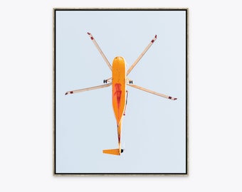 Graphic fine art photograph of yellow fire fighting helicopter photographed from below against baby-blue sky in Santa Barbara, California.