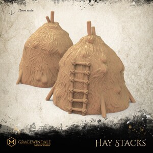 May include: Two miniature hay stacks with a light brown color and textured surface. One stack has a small wooden ladder attached. The text "Hay Stacks" is visible at the bottom of the image. The scale is 32mm.