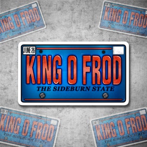 May include: A blue and white license plate sticker with the text "KING O FROD" in red letters and "THE SIDEBURN STATE" in red letters below. The sticker has a white border and a date "JUNE 26" in the top left corner.