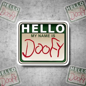 May include: A green and white sticker with the text "HELLO MY NAME IS DOOFY" in red handwritten letters. The sticker is on a gray textured background.