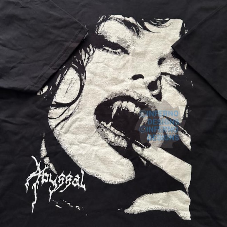 May include: Black t-shirt featuring a detailed, grayscale illustration of a vampire with fangs bared. The word "Abyssal" is printed in a stylized font at the bottom. The design is a bold, graphic statement.