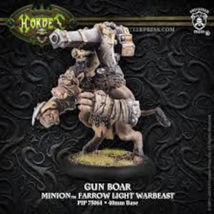 May include: A miniature Gun Boar warbeast figurine. The figurine is a light brown color with a cannon mounted on its back. The base is black with green grass. The text "GUN BOAR" and "MINION Farrow LIGHT WARBEAST" are visible.