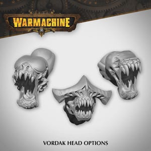 May include: Three unpainted grey miniature creature heads labeled Vordak Head Options. The heads feature sharp teeth, open maws, and distinct cranial structures. The top of the image displays the WarMachine logo in a metallic brown frame.