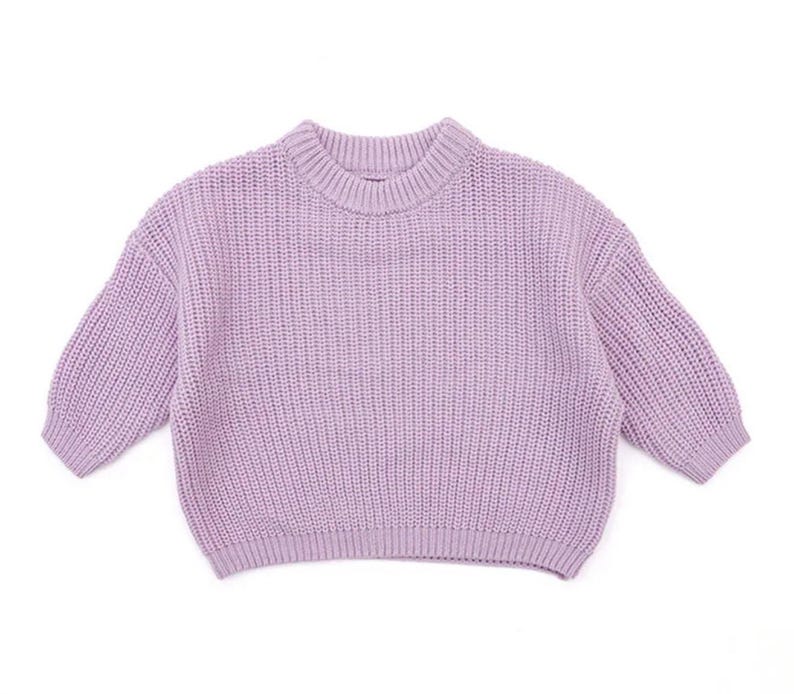 May include: A lavender knitted sweater with a crew neck and long sleeves.
