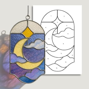 May include: Stained glass pattern featuring a night sky design with a yellow moon, clouds, and a star. The pattern is in shades of blue, purple, and yellow. The image also includes a line drawing of the pattern and the text "SGP STAINED GLASS PATTERNS."