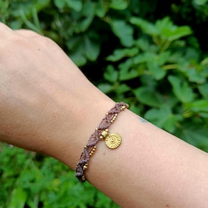 Macrame bracelet with sun pendant