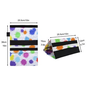 Pu&ograve; includere: Un organizer rettangolare bianco con schizzi di vernice colorati. L'organizer &egrave; alto 38 cm e largo 25,5 cm, con fasce nere e chiusura in velcro. Piegato, forma un triangolo alto 12 cm.