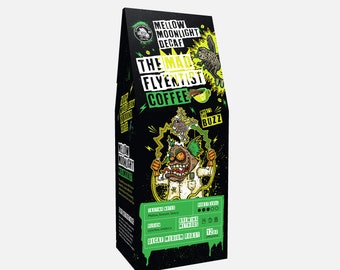 May include: A black and green coffee bag with a cartoon illustration of a mad scientist holding a coffee cup. The bag is labeled "Mellow Moonlight Decaf" and "The Mad Flyentist Coffee". The bag is 12 oz and is a decaf medium roast.