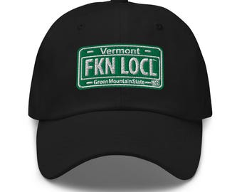 May include: Black baseball cap with an embroidered green license plate that says "Vermont - FKN LOCL - Green Mountain State".