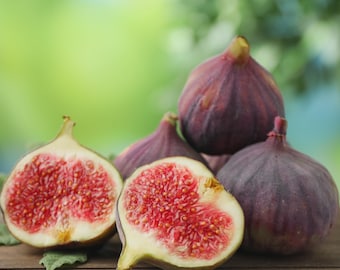 May include: A collection of fresh figs, including two whole dark purple fruits and two halved fruits displaying a light-colored interior flesh filled with numerous small, reddish-pink seeds. The figs are arranged together on a wooden surface.