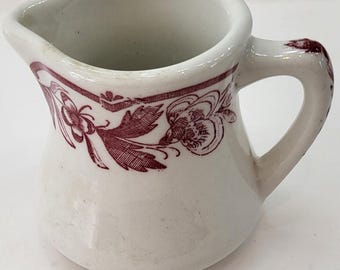 Jarra para crema de porcelana Caribe China Puerto Rico V-1 roja con estampado floral, año 1969.