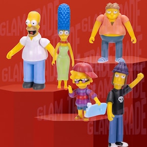 May include: A collection of five Simpsons character figurines. Homer wears a white shirt and blue pants. Marge wears a green dress and has blue hair. Other characters include Bart, Lisa, and Milhouse. The figures are on a red background.