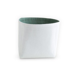 Back view of white fabric storage box with pastel green inside.