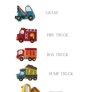 May include: Image features colorful truck charms, including a crane, fire truck, box truck, dump truck, and digger. The text "truck charms" is at the top. Each charm is brightly colored with distinct details, perfect for crafting or jewelry making.