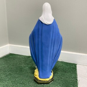 Realistically painted Virgin mary statue with a blue and gold shawl standing on a snake made out of solid concrete making it durable in all weather conditions.