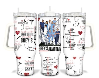 May include: White stainless steel tumbler with a black and white illustration of the Grey's Anatomy cast on a staircase. The tumbler has a handle and a lid with a straw. The tumbler is decorated with red hearts, medical symbols, and the text "Grey's Anatomy", "I just want to drink coffee and watch Grey's", "It's beautiful to save lives", "You're my person", and a list of the main characters' names.