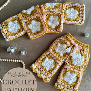 May include: A crochet granny set in mustard yellow, white, and pink, featuring a floral pattern. The set includes a top and shorts, with a drawstring on the shorts. The image also shows decorative beads and disco balls. Text on the image reads "FULL BLOOM Granny Set CROCHET PATTERN".