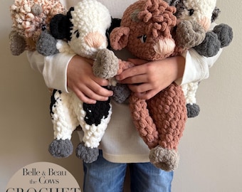 May include: A child holds four crocheted cow plushies. The cows are brown, white and black, and gray. The plushies are made with a chunky yarn and have large, round eyes. The plushies are part of a crochet pattern called "Belle & Beau the Cows Crochet Pattern".