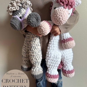 May include: A child holds two crocheted stuffed animals: a gray and white horse with a purple bridle and a white unicorn with pink and white mane and tail. The unicorn has a gold horn. The caption reads "Harlow the Horse (a Unicorn) CROCHET PATTERN PDF English".