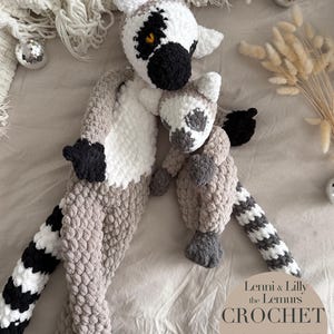 May include: Crochet pattern for two lemur plushies, one large and one small. The lemur plushies are gray, white, and black. The pattern is called "Lemmi & Lilly the Lemurs Crochet Pattern" and is available in PDF format in English.