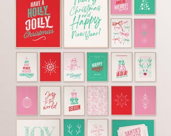 May include: A selection of framed Christmas art prints in red, green, and pink. The prints display festive phrases such as "Merry Christmas," "Happy Holidays," and "Joy to the World," alongside holiday-themed graphics like snowflakes and baubles.