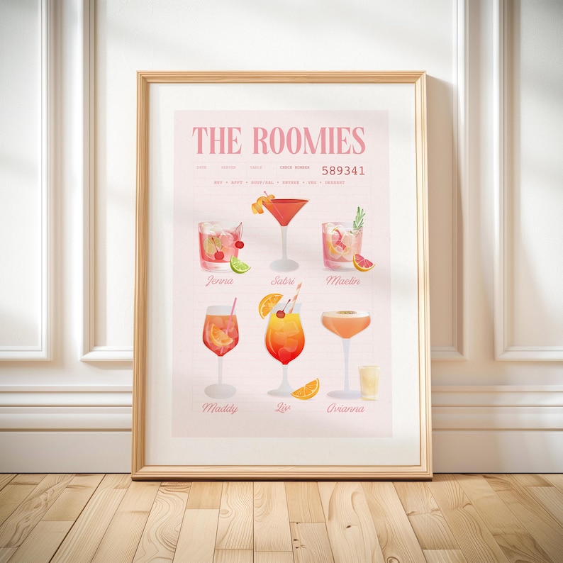 May include: A framed print with watercolour illustrations of cocktails. The print is titled "THE ROOMIES" and includes the names of the cocktails and their ingredients. The colour palette is soft, with pink and orange hues.