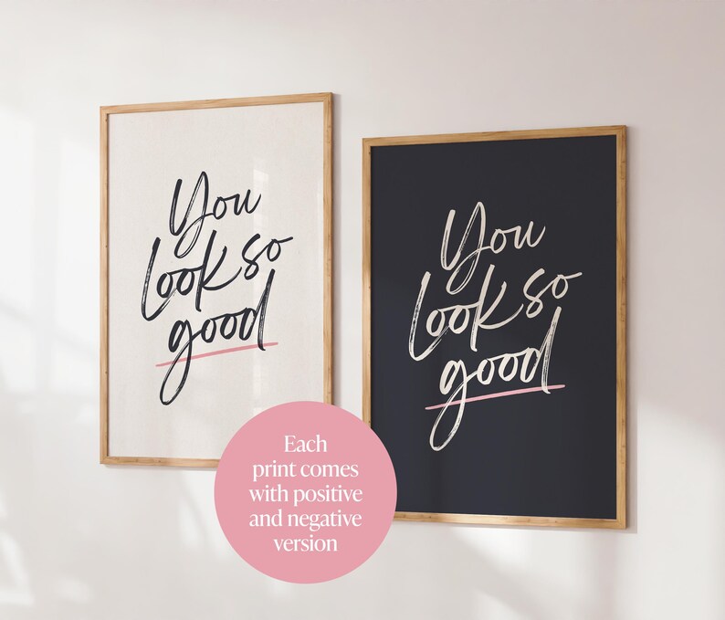 May include: Two framed art prints with the phrase "You look so good" in a handwritten style. One print has a white background with black text and a pink underline, the other has a black background with white text and a pink underline.