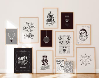 May include: A collection of framed Christmas-themed art prints. The prints feature festive text and illustrations, including reindeer, snowflakes, Santa Claus, and holiday greetings like "Happy Holidays" and "Have a Holly Jolly Christmas."