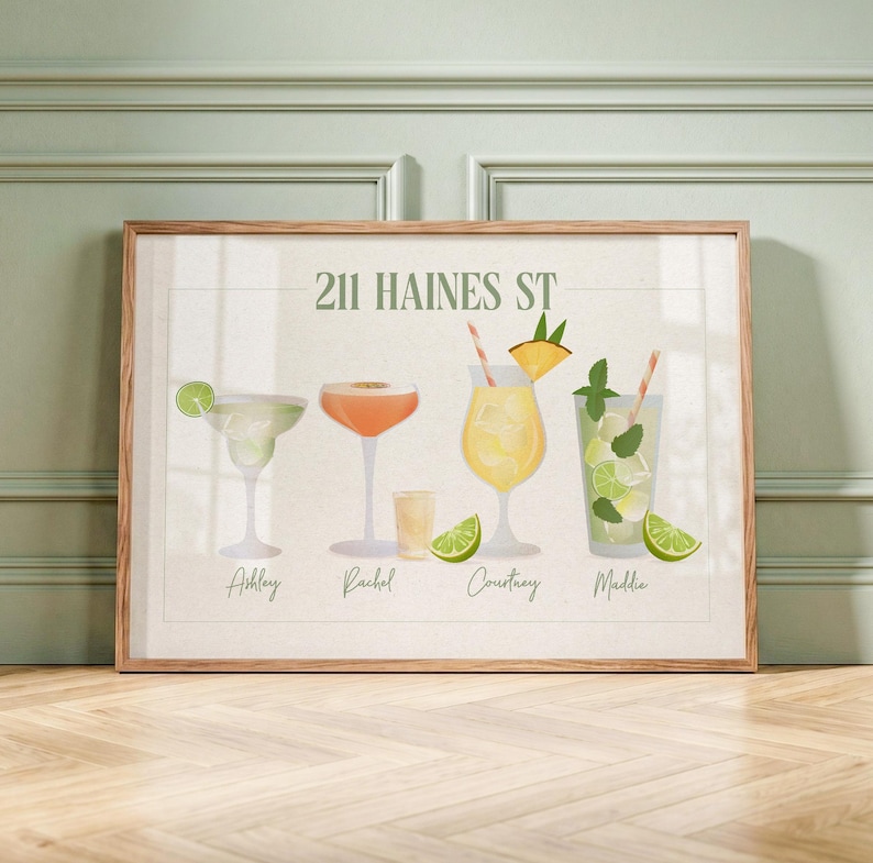 May include: A framed horizontal art print titled 211 HAINES ST featuring four illustrated cocktails with garnishes. The drinks are labeled Ashley, Rachel, Courtney, and Maddie in cursive script. The artwork uses a palette of green, orange, and yellow.