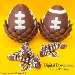 May include: Brown 3D-printed football-themed dragon and egg sculptures on a yellow background. The eggs are brown with white football markings, nestled in brown, petal-like bases. Two dragon figures are also brown with white football details. Text reads "Digital Download For 3D Printing".