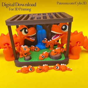 Puede incluir: Una escena familiar de dinosaurios naranjas impresa en 3D dentro de una jaula marrón. La escena incluye dos dinosaurios grandes, varios más pequeños y una cascada azul. El texto "Digital Download For 3D Printing" es visible.