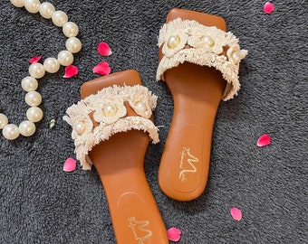 A beautiful Tan fringed  handcrafted pearl Flat sandal, perfect for summer look. Grab your perfect pair.