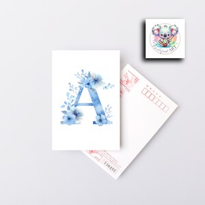 May include: A blue watercolor letter A with blue flowers and leaves around it. The letter is on a white background.