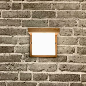 May include: A rectangular, wooden-framed light fixture with a white, frosted glass panel. The fixture is mounted on a brick wall.