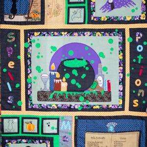 May include: A colourful quilt with a Halloween theme. The quilt features a cauldron with green bubbling liquid, a witch's hat, and a book with a list of ingredients and herbs. The quilt is made of various fabrics and has a patchwork design.