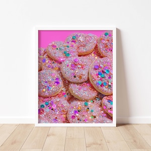 May include: A framed print featuring a close-up of several pink, heart-shaped cookies. Each cookie is generously covered in glitter and colorful sprinkles. The background is a vibrant pink, enhancing the sweet, celebratory theme.