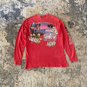 May include: A white ceramic mug with a black handle and the text "But First, Coffee" in a black, bold font. The mug is on a white surface. The mug is 4 inches tall.