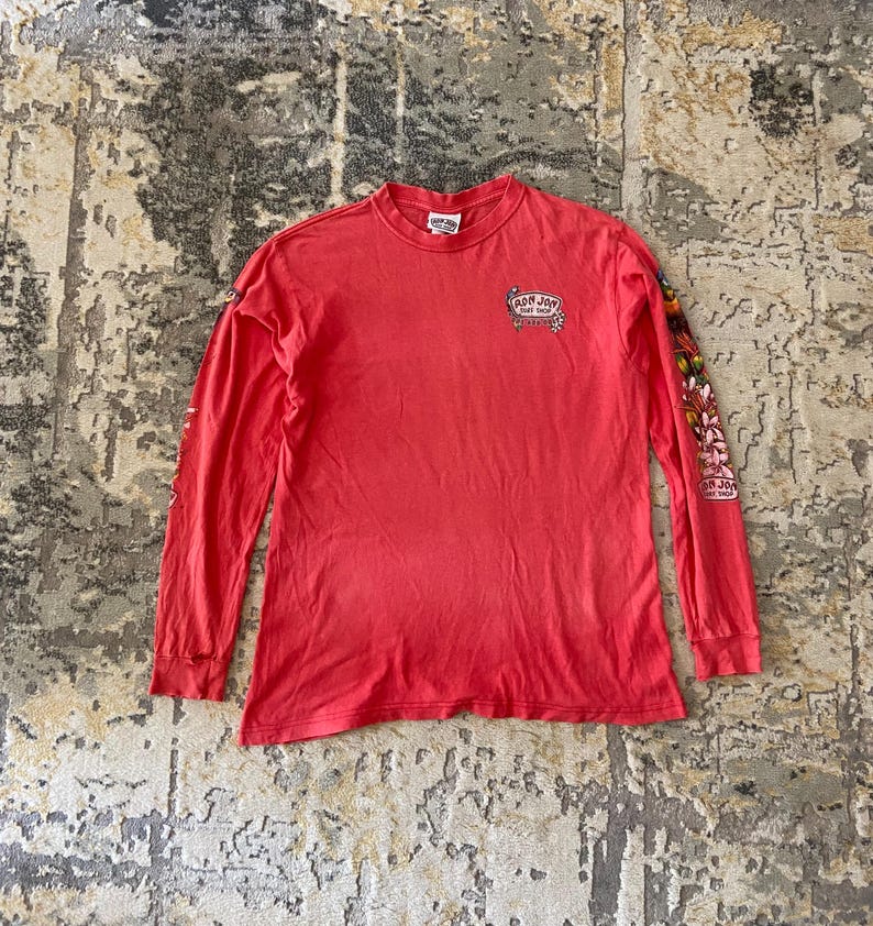 May include: A set of three ceramic canisters with lids, featuring a blue and white floral pattern. The canisters vary in size, with the largest measuring approximately 8 inches in height. They are likely used for kitchen storage.