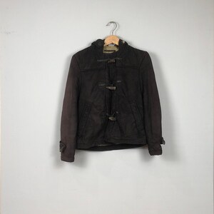 May include: A brown hooded jacket with a toggle closure and a fleece lining.