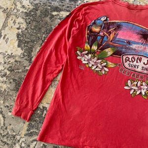 May include: A set of three ceramic mugs with a speckled, matte finish. The mugs are in shades of cream, light gray, and dark gray. Each mug has a simple, minimalist design and a rounded handle.