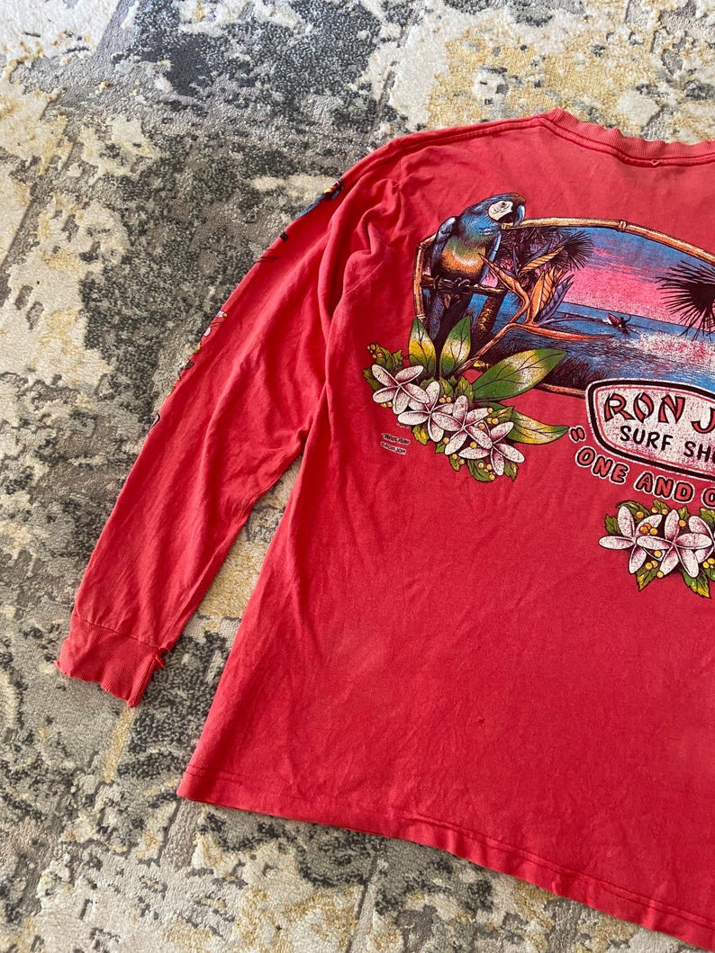 May include: A set of three ceramic mugs with a speckled, matte finish. The mugs are in shades of cream, light gray, and dark gray. Each mug has a simple, minimalist design and a rounded handle.