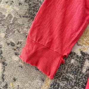 May include: A rustic wooden sign with the text "Welcome to our home" in white lettering. The sign features a distressed finish and a simple, inviting design, perfect for entryway decor.