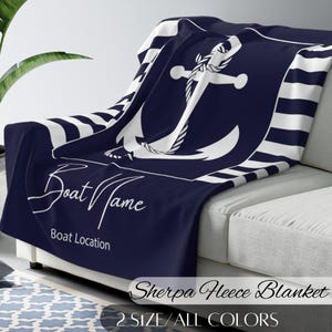 May include: A navy blue sherpa fleece blanket with a white anchor and stripes. The blanket has the text "Boat Name" and "Boat Location" printed on it. Sherpa Fleece Blanket 2 Size/All Colours.
