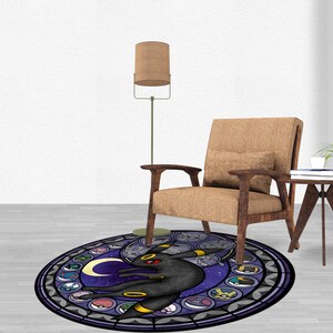May include: A round, purple and black rug with a stained glass design featuring a Pokemon character, a crescent moon, and other Pokemon symbols.