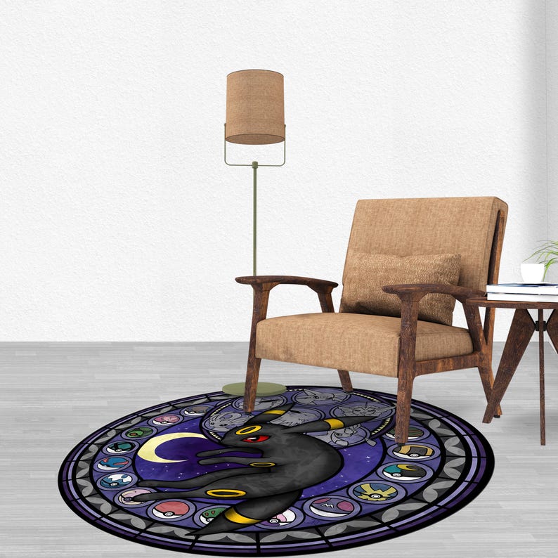 May include: A round, purple and black rug with a stained glass design featuring a Pokemon character, a crescent moon, and other Pokemon symbols.