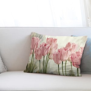 May include: A throw pillow with a floral design featuring pink tulips on a light green background.