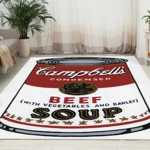 May include: A white rug featuring a red and white Campbell's Soup can design. The can reads "Campbell's Condensed Beef Soup (with vegetables and barley)".