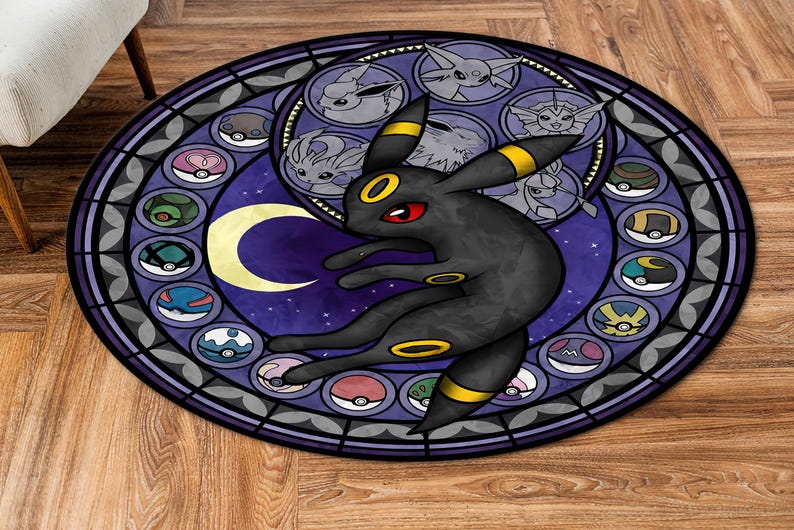 May include: A round, purple and black rug with a stained glass design featuring a black and yellow Pokemon character, surrounded by smaller Pokemon characters and Pokeballs.