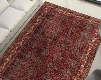 May include: A rectangular, patterned rug with a red and black color scheme. The rug features an intricate design with geometric and floral motifs. The border has a cream-colored pattern. The rug is placed on a light-colored floor.